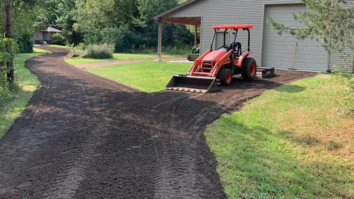 Gravel driveway with potholes ruts and drainage problems
