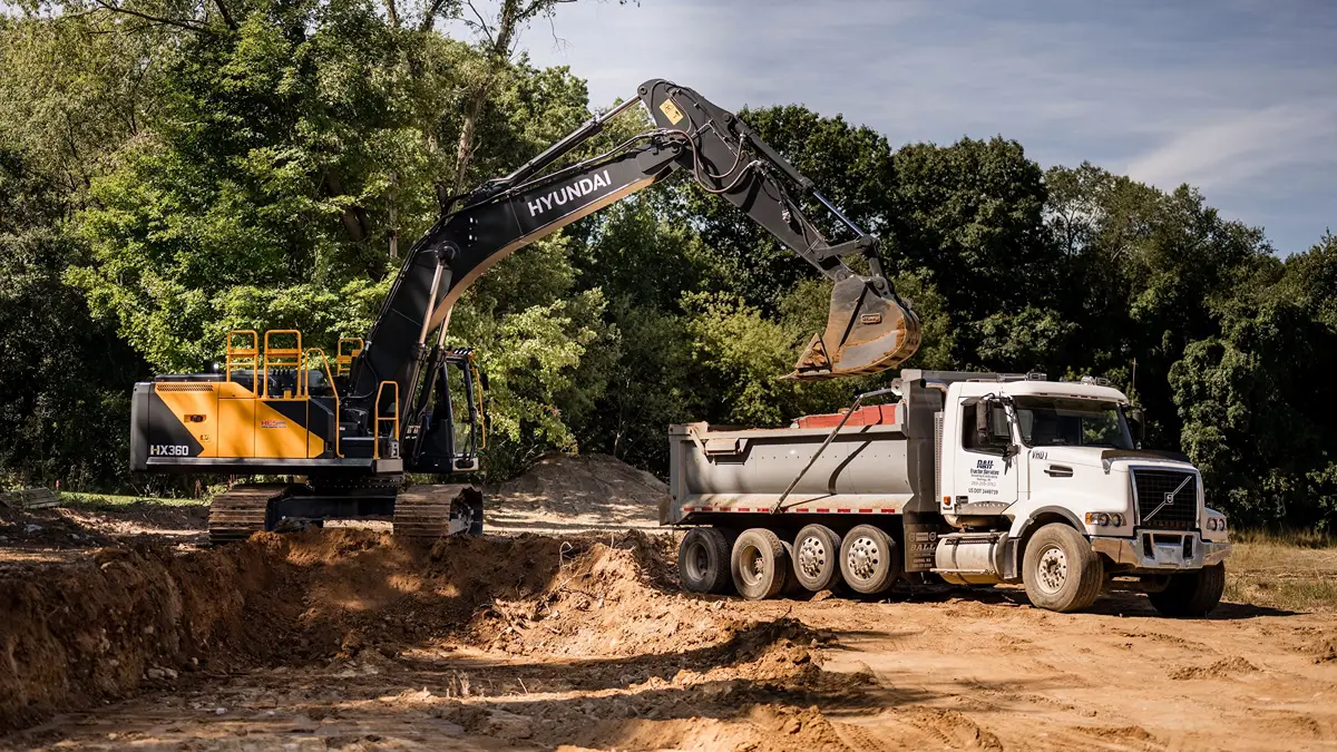 Sloped residential building site requiring clearing excavation drainage and grading