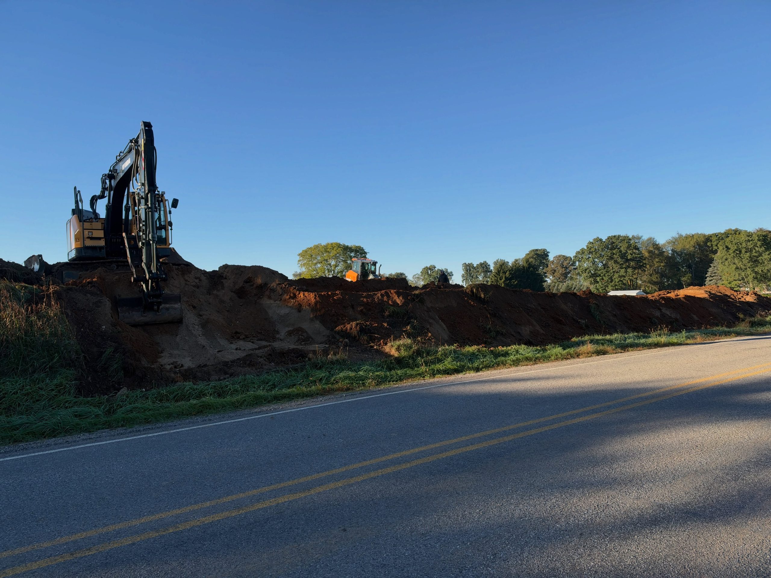 Grading work during Middleville barndominium site preparation